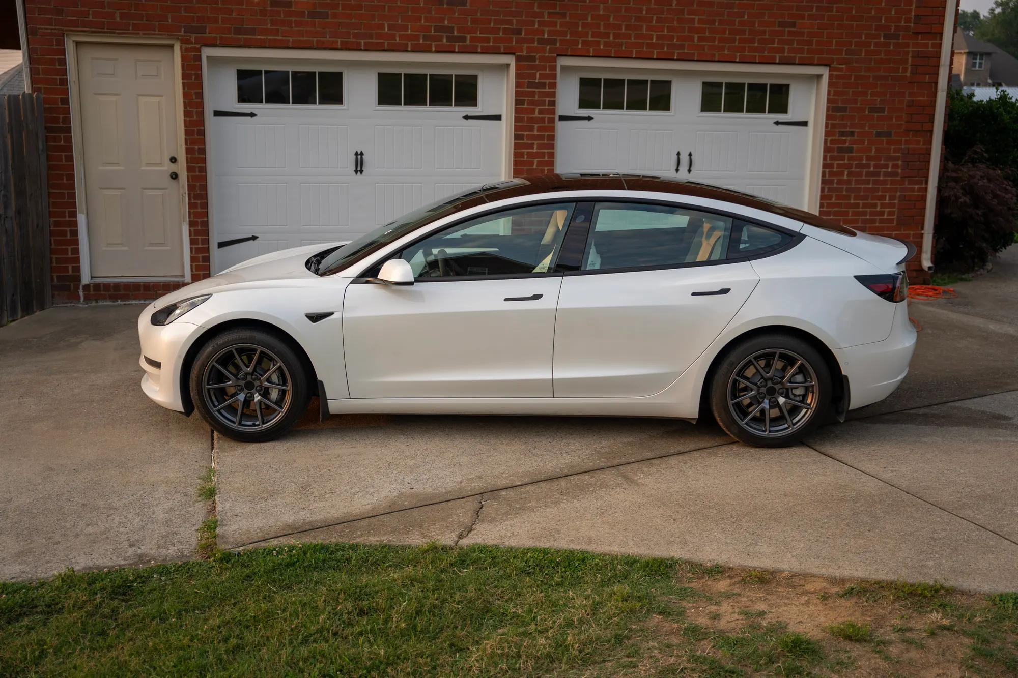 Freshly detailed white Tesla in a driveway